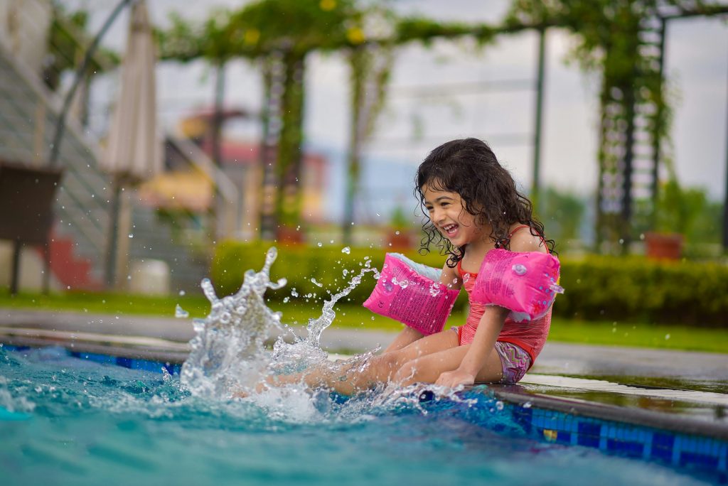 girls splashing in pool