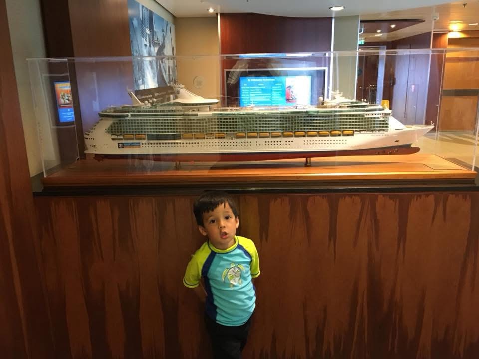 boy in front of model ship statue